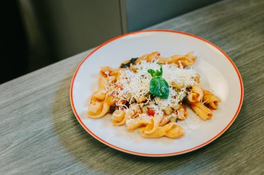 A plate of traditional Italian dish pasta for lunch in a cafe. Selective focus.