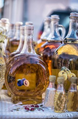 Traditional Balkan brandies in the bottles on the market stall