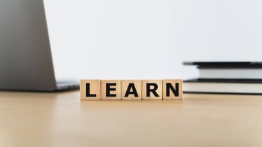 LEARN wording with book or textbook and laptop. Growth idea of business working and education learning success. Businessperson and student skill training and knowledge development
