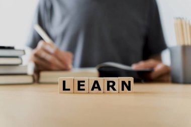 LEARN wording with book or textbook and pencil. Growth idea of business working and education learning success. Businessperson and student skill training and knowledge development