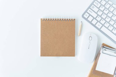 Top view of modern working desk with keyboard, pencil, notebook or notepad. Flat lay photography of business workplace and education learning concept. Conceptual of still life and lifestyles