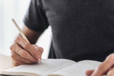 University student studying, writing and reading book or textbook. Learning or training skill course or classroom online at home. Idea of education success. Knowledge and cognition conceptual.