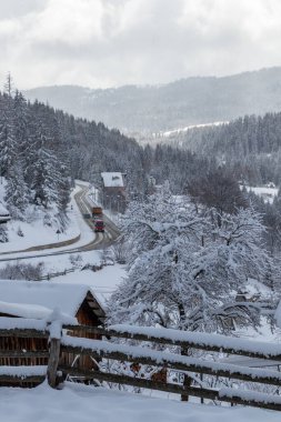 Road in winter forest, landscape with frozen way covered snow.