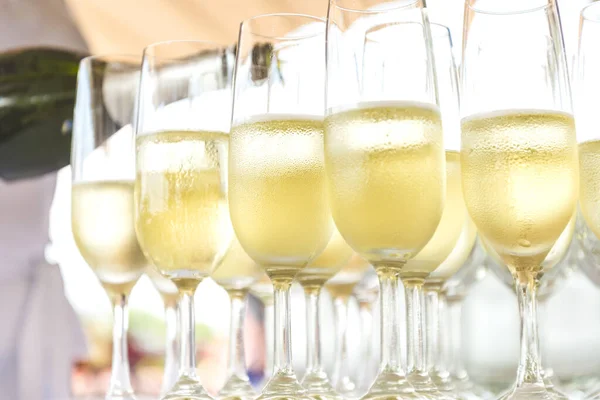 stock image a group of misted glasses of champagne close-up. waiter pouring sparkling wine into glasses