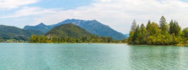 East shore of Lake Wolfgangsee, forests and mountains, hill Burgl near Strobl, Alps, Austria clipart