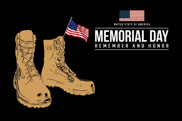 Memorial Day. Old military combat boots and a small American flag on black background close up.