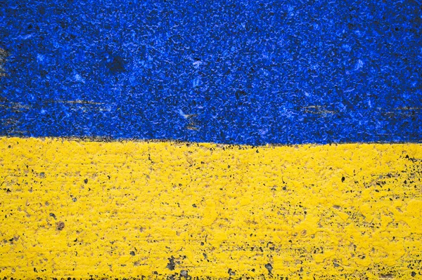 stock image Flag of Ukraine painted with paints on the pavement close up.