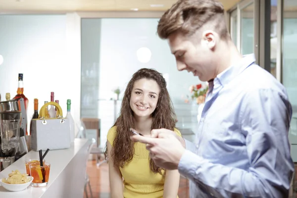 Smiling Nice Girl Looking Her Radiant Boyfriend While Using His — Stock Photo, Image
