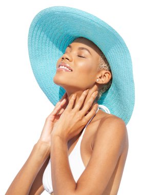 Turkuaz şapka ve bikini giyen gülümseyen bir kız beyaz arka planda izole edilmiş Afrikalı Latin Amerikalı bir kadını harika hissediyor. Deniz kenarı tatili ya da yaz tatili alışverişi kavramı
