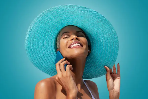 Happy Woman Portrait Wearing Blue Sun Hat Using Mobile Phone Stock Picture