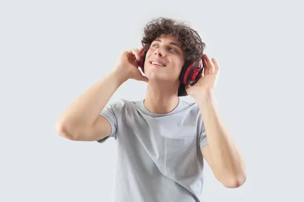 Smiling Handsome Young Man Wears Headphones Isolated Gray Background Looks Stockfoto