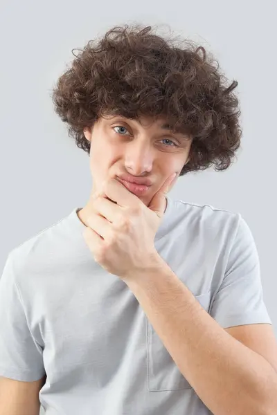 Funny Handsome Young Man Curly Hair Looks Camera His Blue Rechtenvrije Stockfoto's