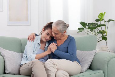 Yaşlı büyükannesine bakması, üzgün torununu evde kucaklaması ve teselli etmesi. Zor zamanlarda sevgi, empati ve nesiller arası destek gösteren duygusal ve dokunaklı bir aile anı.