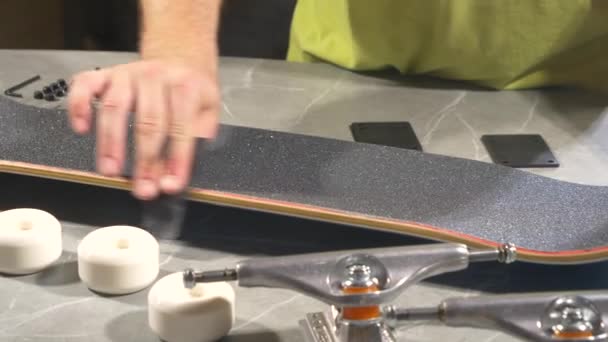 Close Young Male Person Smoothing Cut Edges Skateboard Griptape Leftover — Stock Video