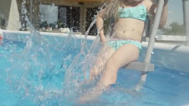 Close Little Girl Sitting Pool Steps Making Water Splashes Pool — Stock Video