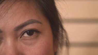 Yaklaş, PORTRAIT: ayrıntılı bir bakış Filipinli güzel kahverengi göz. Çekici Asyalı kadın poz veriyor ve doğrudan kameraya bakıyor. Genç bir bayanın büyüleyici kahverengi gözünün güzel bir fotoğrafı..