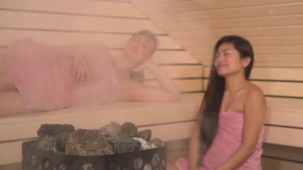 Close Steaming Sauna Stones Beautiful Ladies Relaxing Background Two Attractive — Vídeos de Stock
