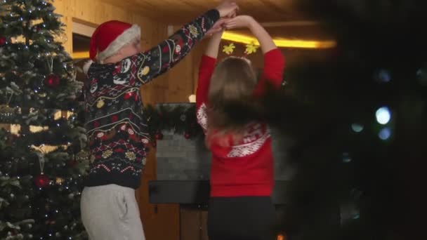 Young Man Lifts His Girlfriend While Dance Together Christmas Tree — Vídeo de Stock