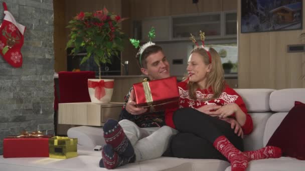 Young Man Delights His Girlfriend Giving Her Present Christmas Holidays — Stock Video