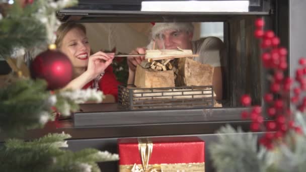 Joyful Couple Starting Fire Fireplace Cosy Warm Christmas Eve Smiling — Wideo stockowe