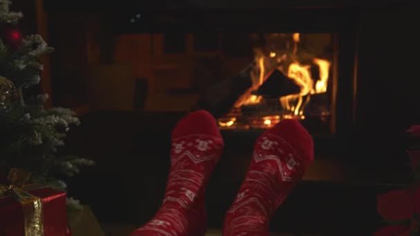 Close Woman Relaxing Fireplace Wiggling Her Feet Christmas Socks Female — Stockvideo