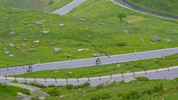 Two Active Tourists Ride Bikes Wet Switchback Road High Picturesque — Zdjęcie stockowe
