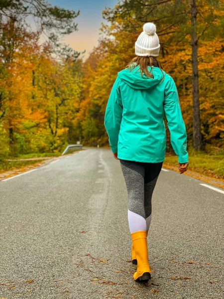 Young Female Traveler Wearing Yellow Rubber Boots Walks Empty Road — Φωτογραφία Αρχείου