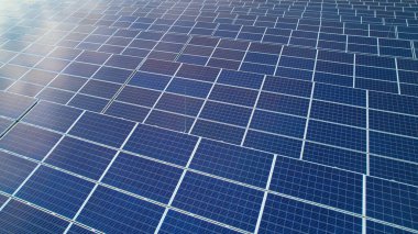 AERIAL: Ordered array of solar collectors for sustainable electric production. Solar-powered technology for more sustainable future. Photovoltaic power station as a means of generating electricity.