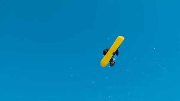 Bottom Athletic Snowboarder Flying Air Doing 360 Grab Sunny Winter — Zdjęcie stockowe