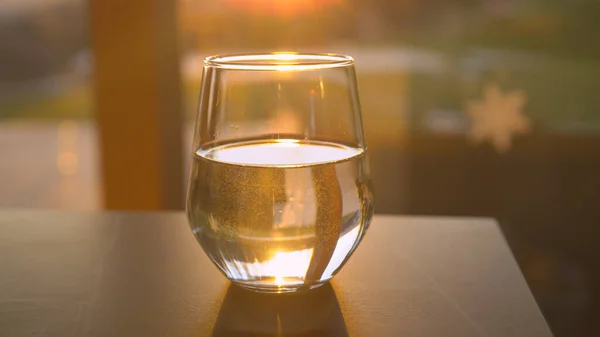 Close Fresh Water Glass Jar Backlit Golden Sunlight Placed Table — Zdjęcie stockowe