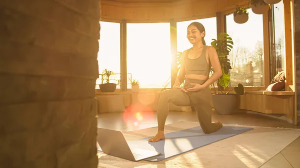 Smiling Asian Woman Crescent Lunge Pose Enjoying Online Yoga Workout — стоковое фото