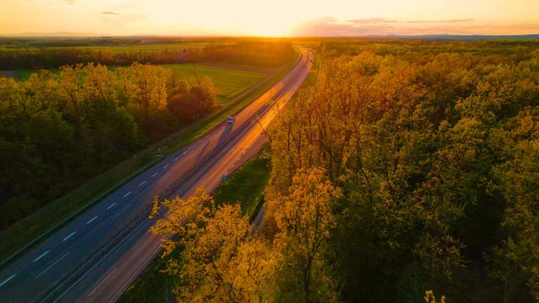 Aerial Vehicles Moving Glowing Motorway Surrounded Trees Sunset Low Traffic — Stock Photo, Image