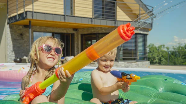 Close Happy Brother Sister Having Fun Water Fight Garden Pool — стоковое фото