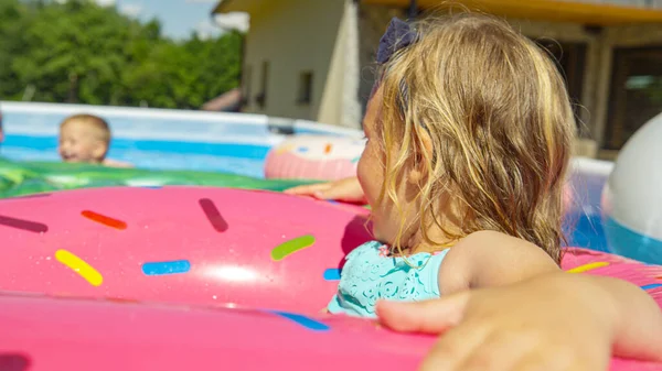 Sevimli Kız Yüzme Havuzunda Şişme Donutta Yüzmekten Zevk Alıyor Neşeli — Stok fotoğraf
