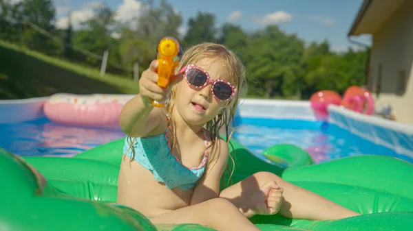 Close Adorable Girl Sitting Floatie Garden Pool Holding Water Gun — 图库照片