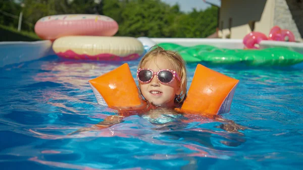 Portrait Cheerful Girl Sunglasses Swimming Pool Water Wings Cute Girl — Stok fotoğraf