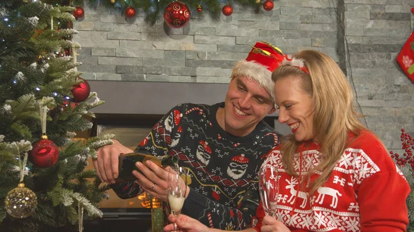 Cheerful Couple Opening Bottle Champagne Celebrating Christmas Holidays Smiling Handsome — Stockfoto