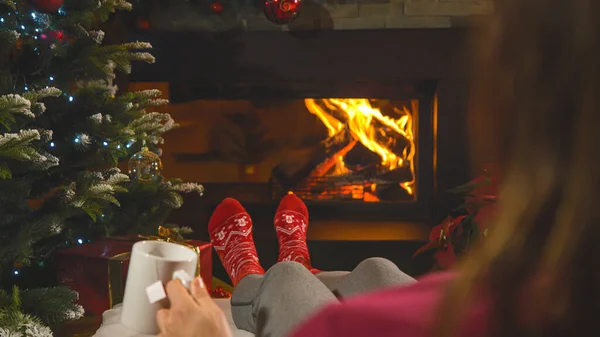 Woman Red Christmas Socks Holding Cup Tea While Resting Fireplace — 图库照片