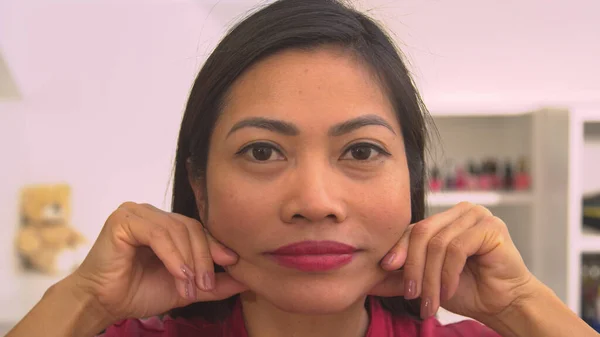 Headshot Beautiful Asian Woman Treating Herself Facial Massage Pretty Young Imagen de archivo