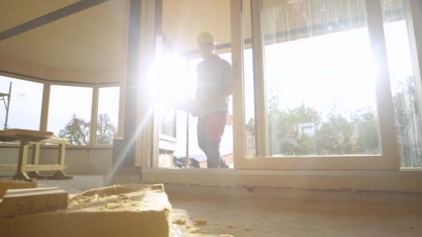 Slow Motion Lens Flare Low Angle Man Carrying Log House — Video