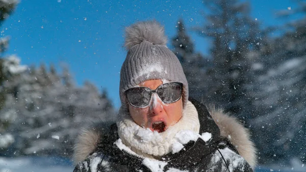 CLOSE UP: Woman is shocked after being struck in the face by a big snowball.