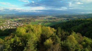 Beautiful springtime view of rural town Stina and its historic monastery. Picturesque hilly countryside in vibrant spring colors surrounding idyllic village and small cloister on a sunny day