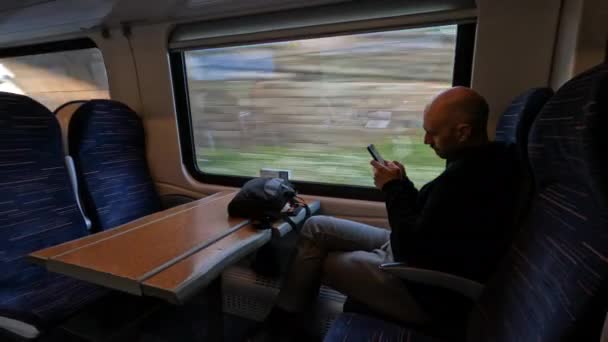 Male Passenger Sits Comfortably Window Uses His Phone Relaxing Train — Stock Video