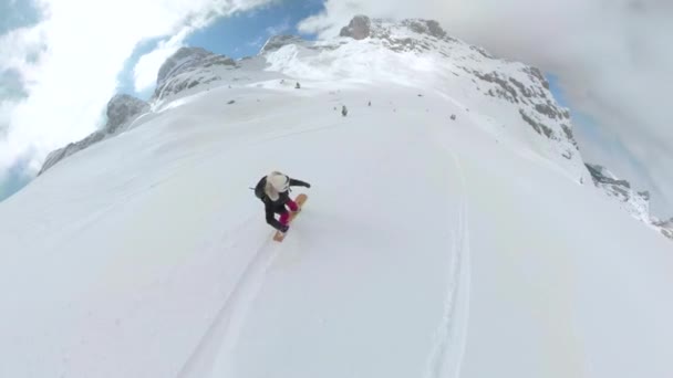 アルバニアアルプス アルバニア December 2023 360 Selfie 美しいアルバニアアルプスの新鮮な粉雪の中でクルージングする女性 彼女はスノーボードで別の乗り物に乗るためにヘリコプターに向かって降りる — ストック動画