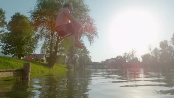 Slow Motion Lens Flare Youthful Man Jumps Water Creates Huge — Vídeos de Stock