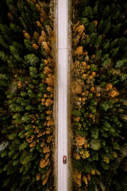 Aerial view of fall road with autumn woods and first snow in Finland, Lapland