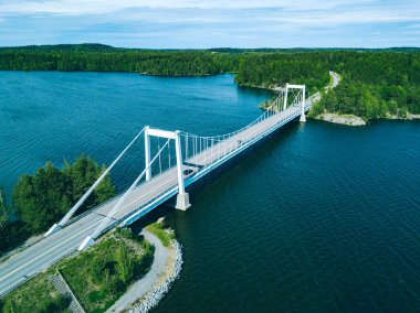 Aerial view of white cable-stayed bridge in Finland. Beautiful summer landscape with blue lakes, green woods and white suspension bridge
