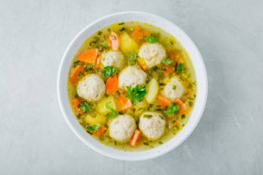 Meatballs soup. Chicken turkey vegetables meatballs soup with carrots and potatoes. Top view, copy space