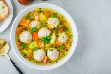 Meatballs soup. Chicken turkey vegetables meatballs soup with carrots and potatoes. Top view, copy space