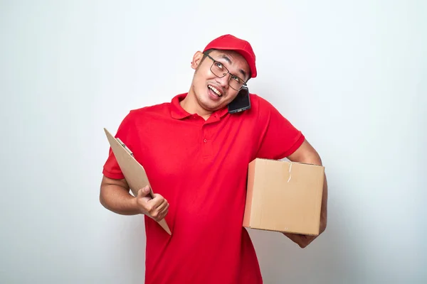 Smiling Busy Asian Courier Man Answering Phone Call Holding Mobile — Stock Photo, Image